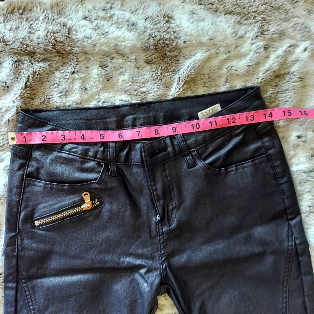 Coated black skinny pants